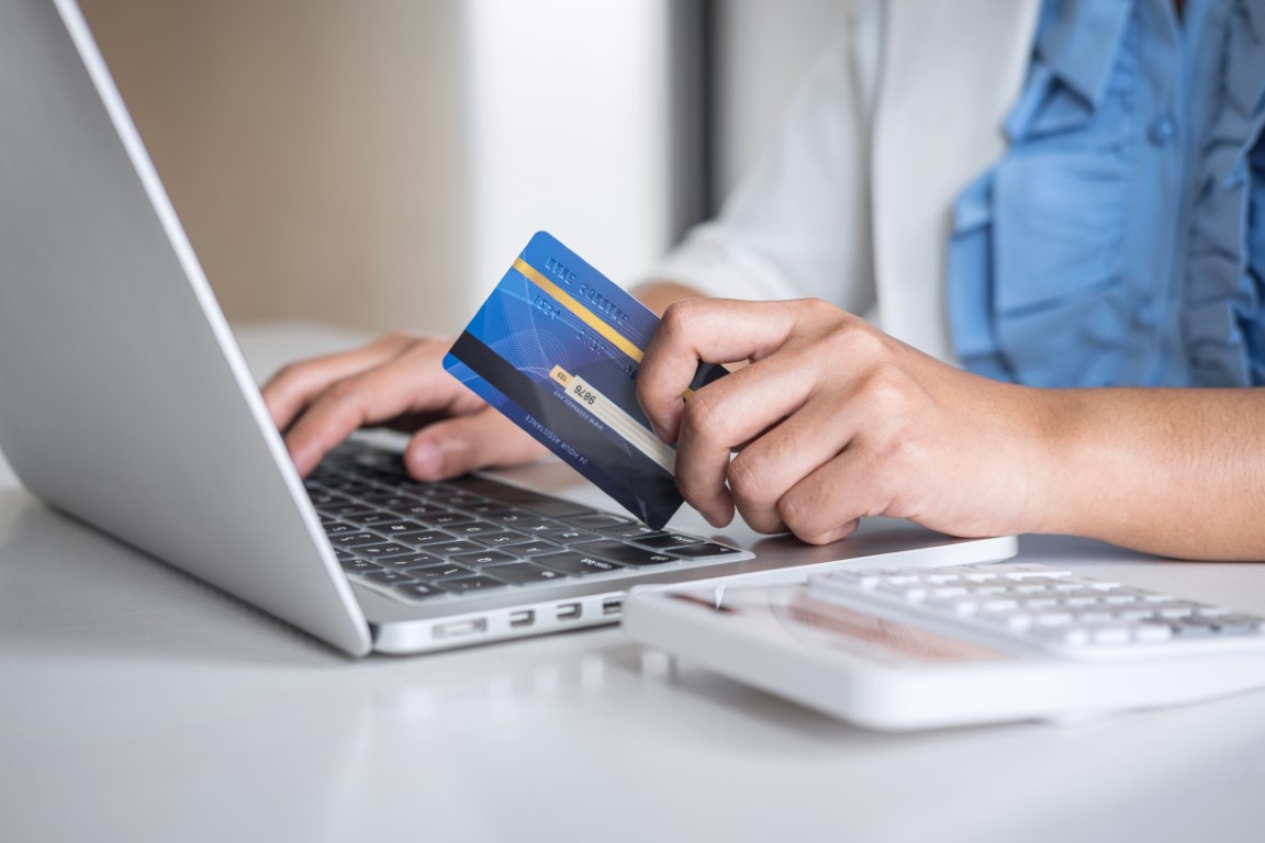 Business woman consumer holding credit card and typing on laptop for online shopping and payment make a purchase on the Internet, Online payment, networking and buy product technology.